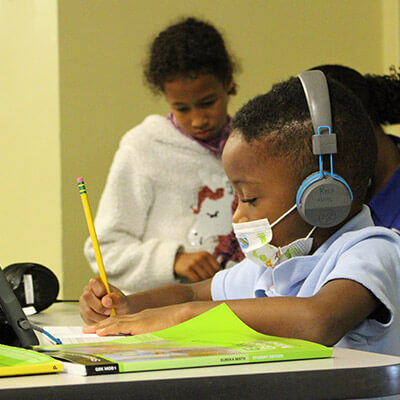 student at desk with headphones on