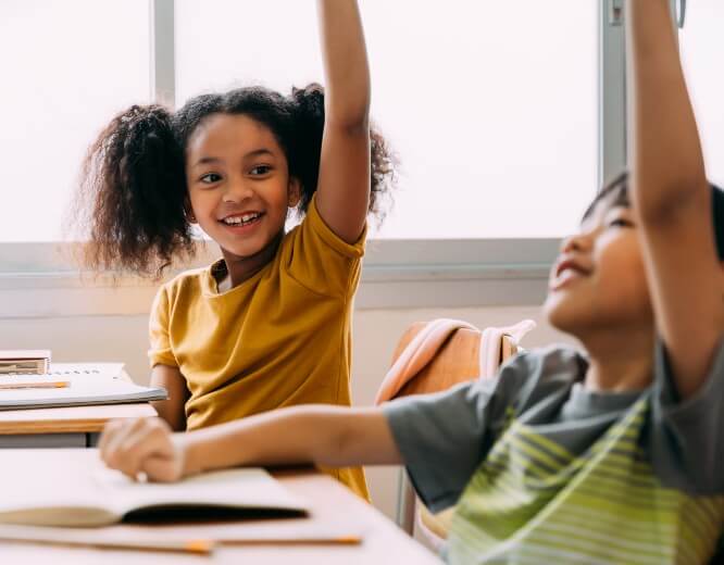 elementary kids raising hands