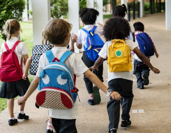 kids with backpacks going to school