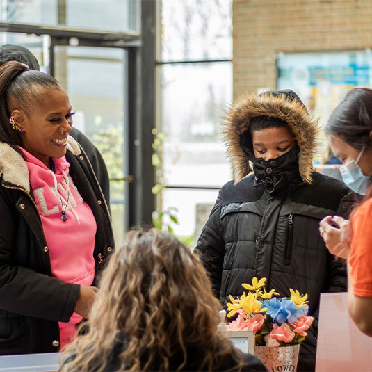 Mother and son attend Indy High School Fair hosted by The Mind Trust.