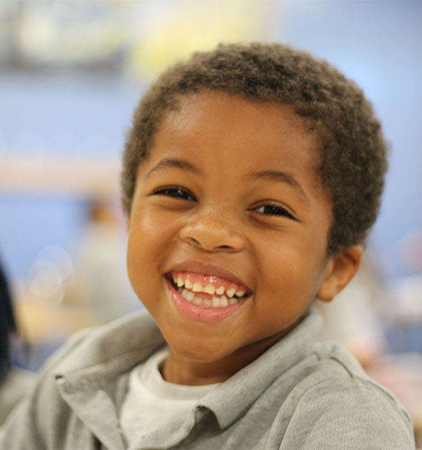 Young boy grinning.