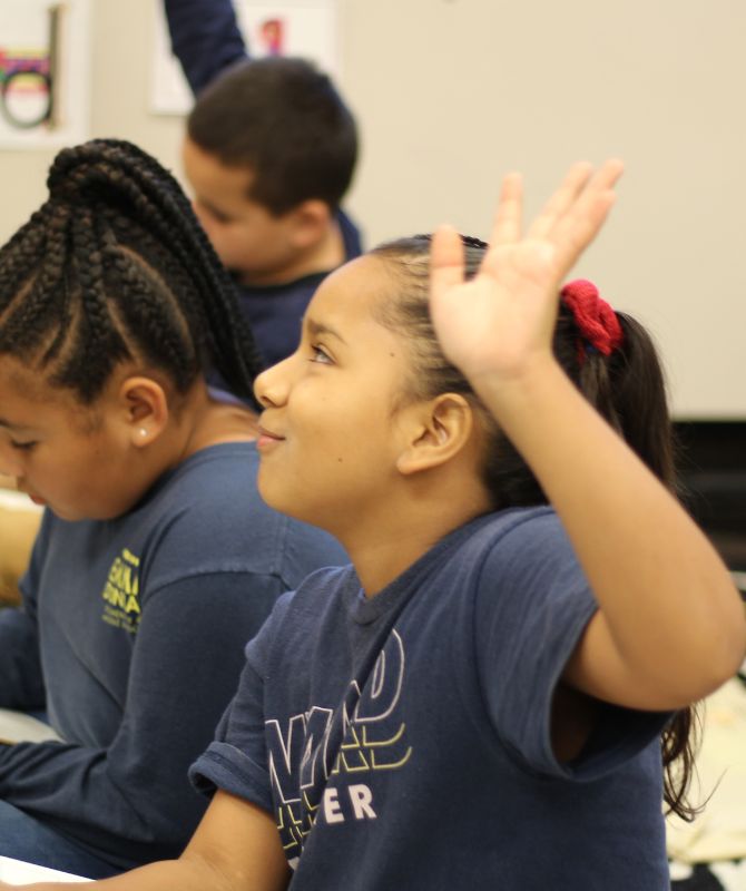 Girl raising hand in class