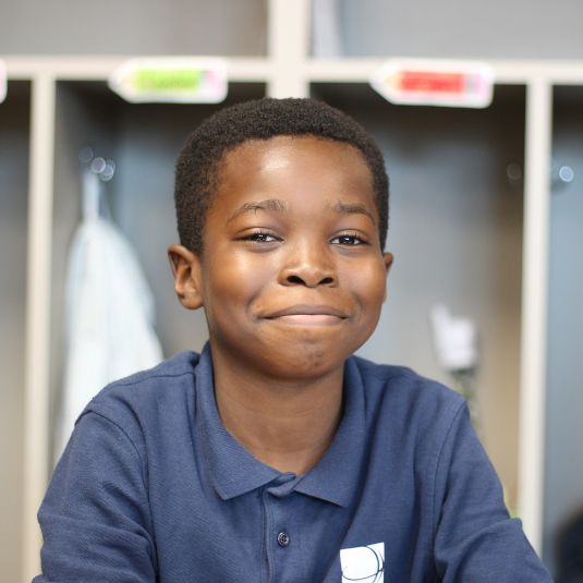 Boy in elementary classroom smiling