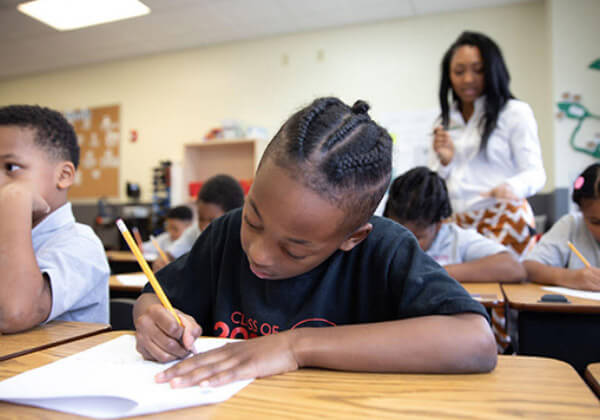 student writing at desk