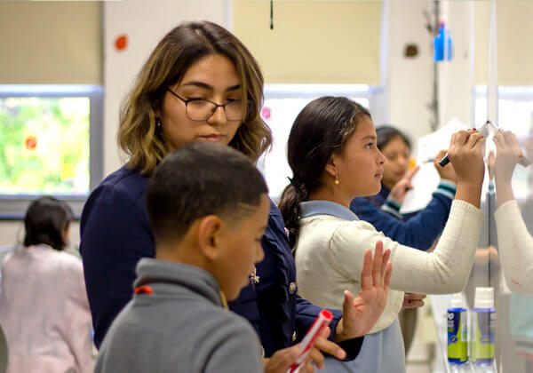 teacher helping student with math