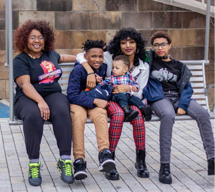 family sitting on a bench together